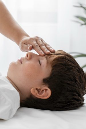 osteopathist-treating-kid-by-massaging-his-head